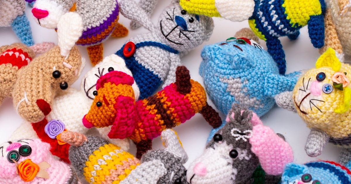 A vibrant collection of crocheted animal toys in various colors and designs.