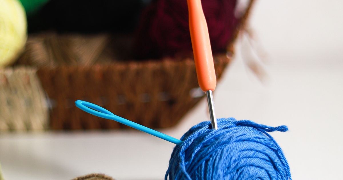 Colorful yarn balls and crochet hooks on a table, ready for a new project.