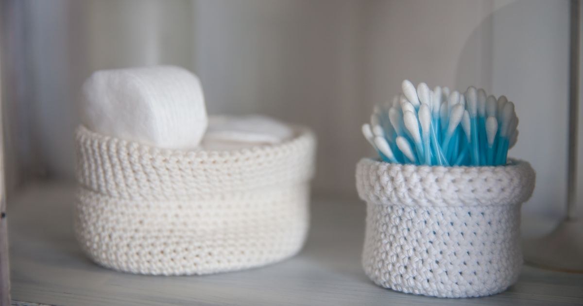 Crocheted baskets holding bathroom items