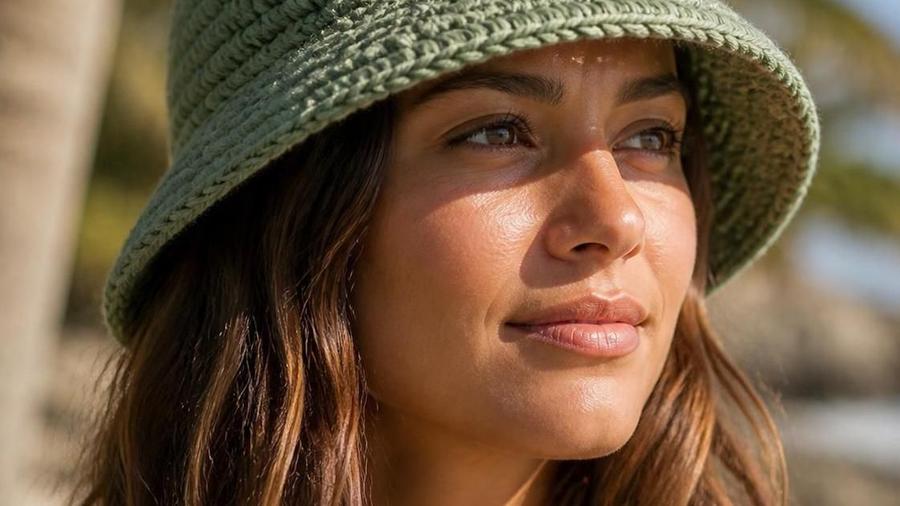 A structured cotton crochet bucket hat with a flared brim, laid flat on a neutral background.
