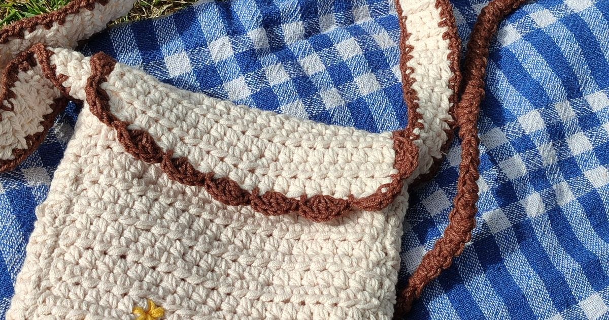 Crochet bag resting on a picnic blanket