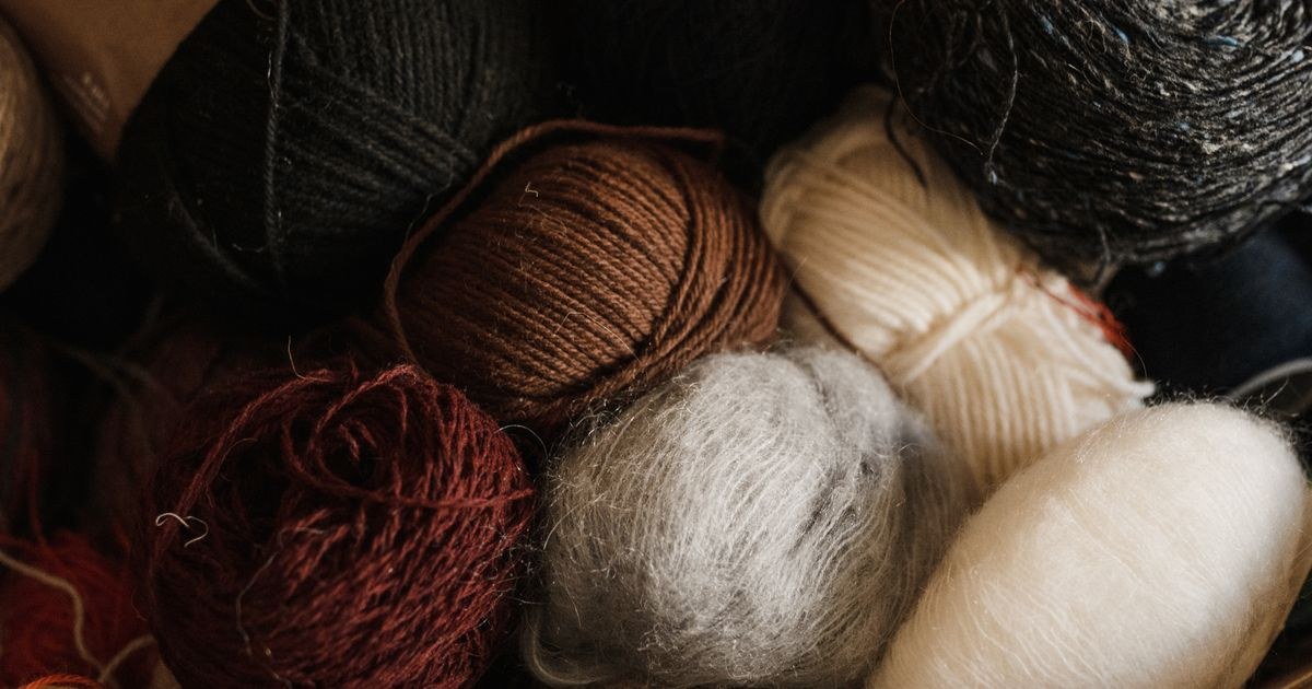 Close-up view of assorted colorful yarn balls, ready for storage.