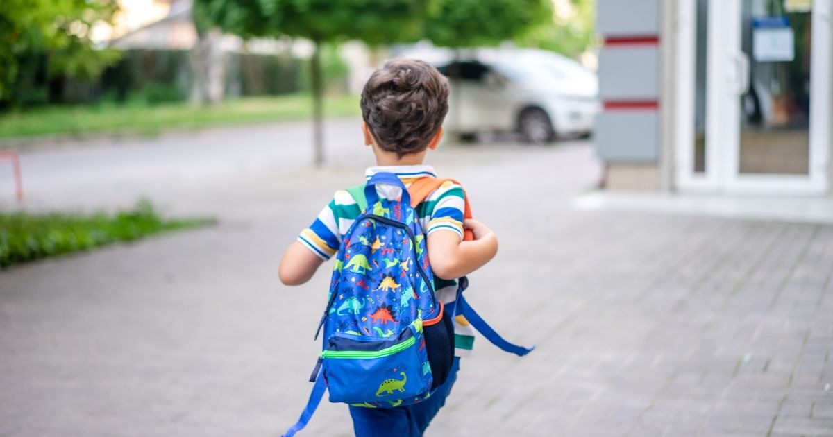 Child walking with a colorful backpack