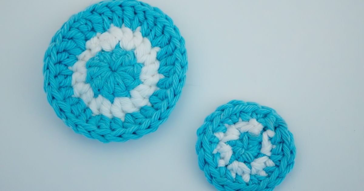 Close-up of handmade blue and white crocheted coasters.