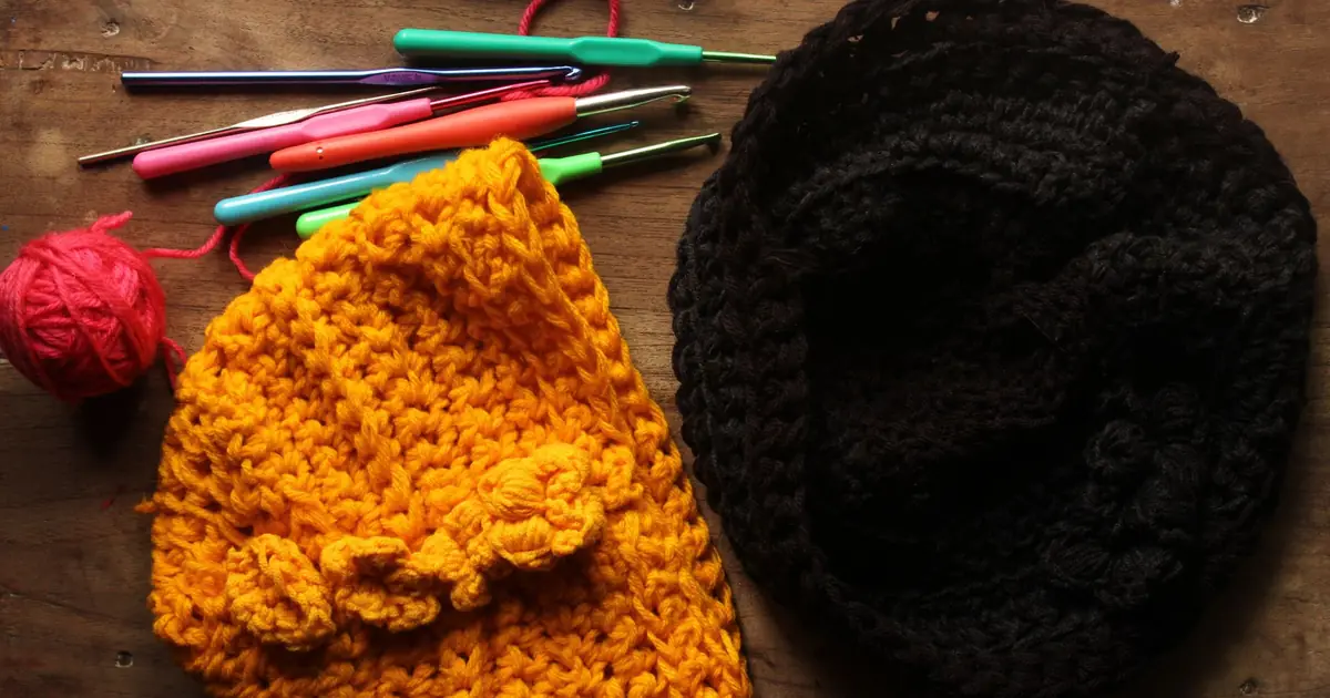 Vibrant crochet beanies with yarn and hooks.