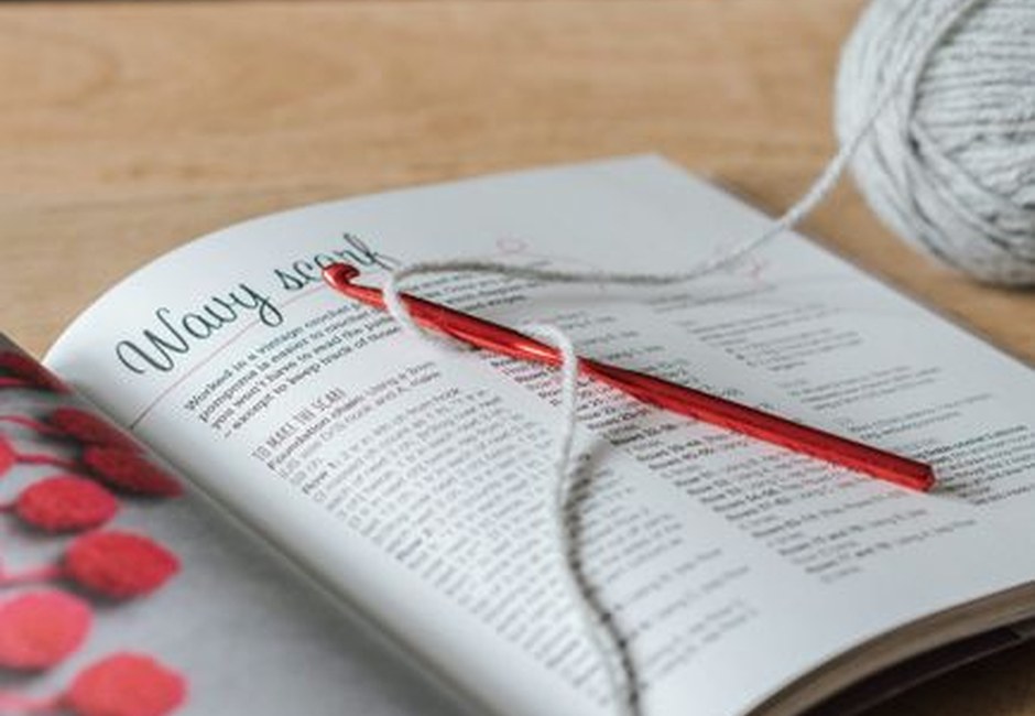 Yarn ball with crochet hook and craft magazine